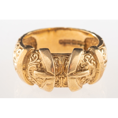 1064 - A 9ct gold buckle ring, an ornately carved buckle ring, UK import mark, size V, 11.1grams.