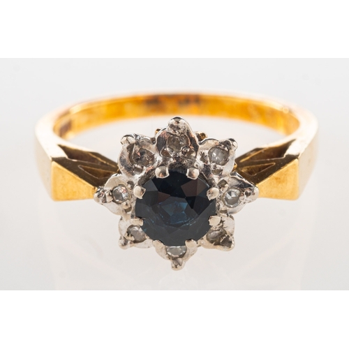 1069 - A sapphire and diamond ring, of flowerhead form and claw set to the centre with a circular-cut sapph... 