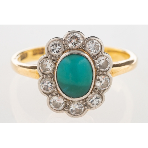 1073 - A turquoise and diamond cluster ring, set to the centre with an oval-cut turquoise cabochon with a s... 