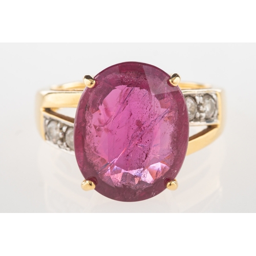 1102 - An 18ct gold ruby and diamond ring, claw set with an oval-cut ruby, ruby approx. 5.35 carats, with t... 