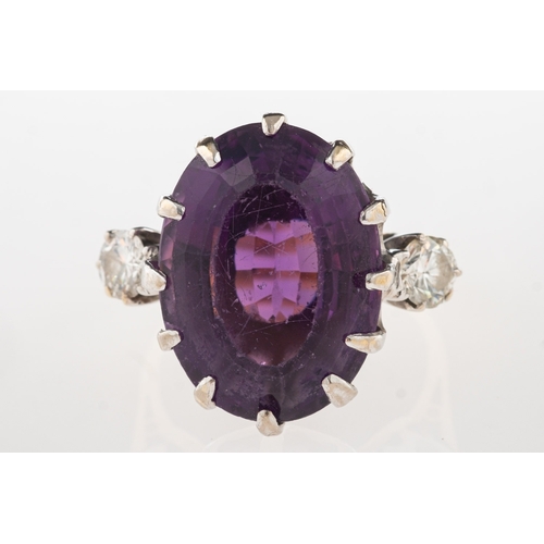 1103 - An 18ct gold amethyst and diamond ring, claw set with an oval-cut amethyst, amethyst approx. 14.24 c... 