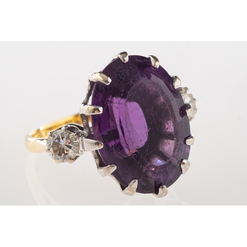 1103 - An 18ct gold amethyst and diamond ring, claw set with an oval-cut amethyst, amethyst approx. 14.24 c... 