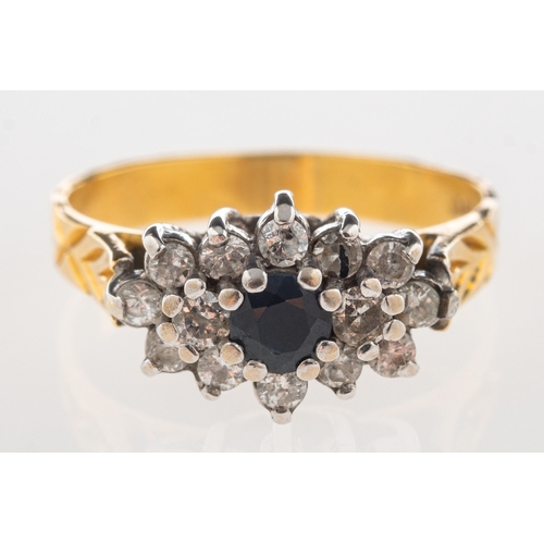 1106 - An 18ct gold sapphire and diamond cluster ring, set to the centre with a circular-cut dark blue sapp... 