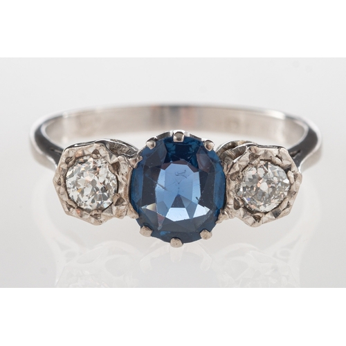 1112 - An 18ct gold sapphire and diamond three stone ring, claw set to the centre with an oval-cut sapphire... 