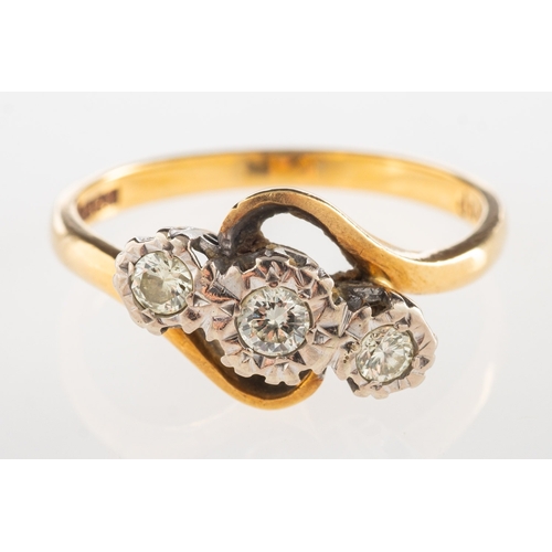 1114 - An 18ct gold three stone diamond twist ring, illusion set with three brilliant-cut diamonds, UK hall... 