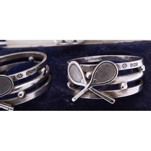 229 - A mixed group of silver ball sports napkin rings including; a cased pair of cast tennis rings by Wil... 