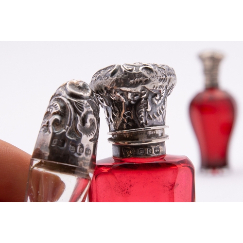 273 - A mixed group of scent bottles including; a cranberry glass and silver bottle, Birmingham 1898, make... 