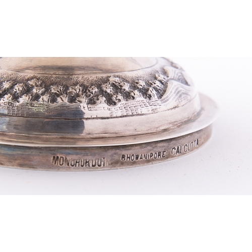 310 - An Indian silver bowl by Mondhuden Bhowanipore Calcutta marked on the base, the wavy rim above an em... 