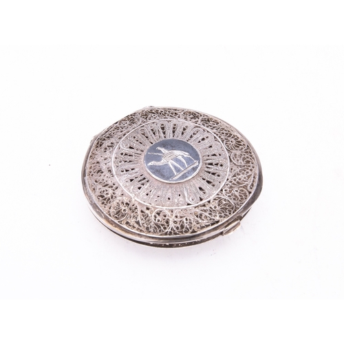 323 - A mid 20th century Iraqi silver compact with filigree cover, un-marked, niello decoration of dhows, ... 