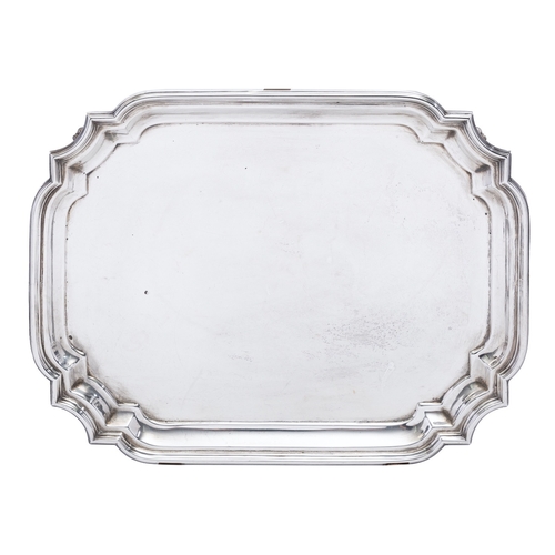 391 - A George V silver salver by Walker and Hall, Sheffield 1912, of canted rectangular form, raised on f... 