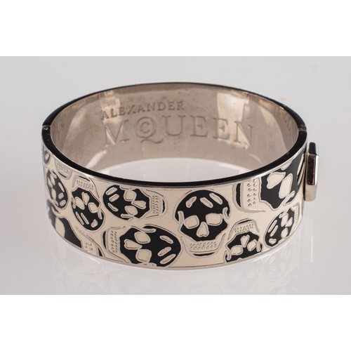 402 - Alexander McQueen. A Skull bangle, a hinged bangle with classic black and white enamelled skull desi... 