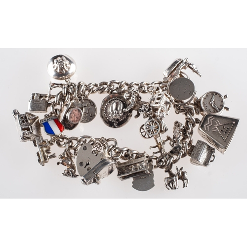 406 - A silver charm bracelet with charms, of curb links with heart padlock and safety chain, heart padloc... 