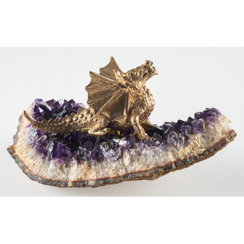 414 - A 9ct gold model of a dragon sat atop a slice of amethyst geode, designed by Phil Read for the Expre... 