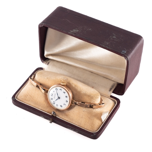 448 - Rolex, a vintage ladies gold wristwatch the round white dial having black Arabic numerals, blued ste... 