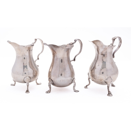 61 - A mixed group of silver including; three mid 20th century cream jugs of baluster form, C scroll hand... 