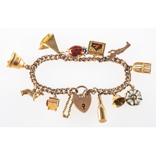 625 - A charm bracelet with charms, the charm bracelet having a heart padlock and safety chain, the heart ... 