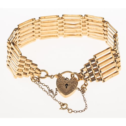 675 - A gate bracelet with heart padlock, the heart padlock with foliate engraving to front, safety chain,... 