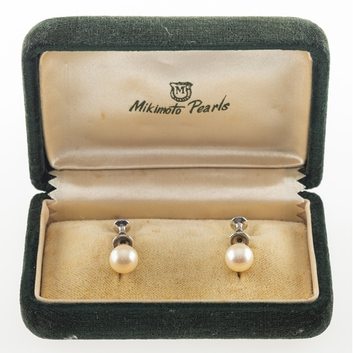 680 - Mikimoto. A pair of cultured pearl earrings, each screw back earring set with a single cultured Miki... 