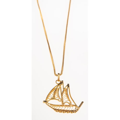 682 - A boat pendant with chain, an openwork filigree pendant in the form of a sailing boat, indistinct ma... 