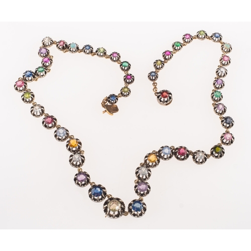 685 - A multi-stone gem-set necklace, claw set with an array of multi-coloured gemstones including a centr... 