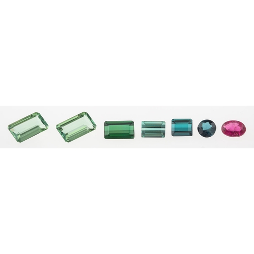 755 - A group of seven loose semi-precious gemstones: A loose emerald-cut green tourmaline, approx. 1.90 c... 