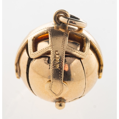 763 - A Masonic ball pendant, opening to reveal engraved Masonic symbols in a cruciform design, marked 'Ma... 