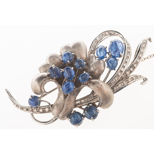 810 - A sapphire and diamond brooch, of flower and foliate form with a brushed and polished finish and set... 