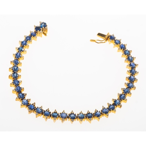 826 - A sapphire and diamond line bracelet, of articulated links, claw set with thirty-seven oval-cut sapp... 