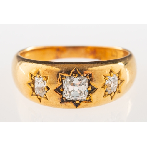 848 - An antique three stone diamond ring, star set to the centre with an old mine-cut diamond, with an ol... 