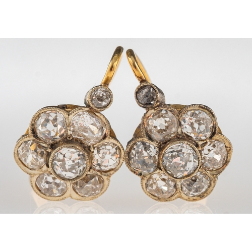 876 - A pair of early 20th century diamond flower earrings, each of flowerhead form, set with old-cut diam... 