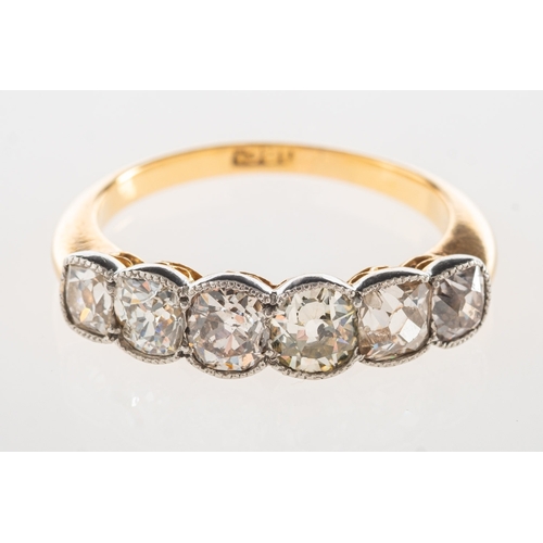 887 - A six stone diamond ring, a half hoop ring collet and milgrain set with six old cushion/oval-cut dia... 