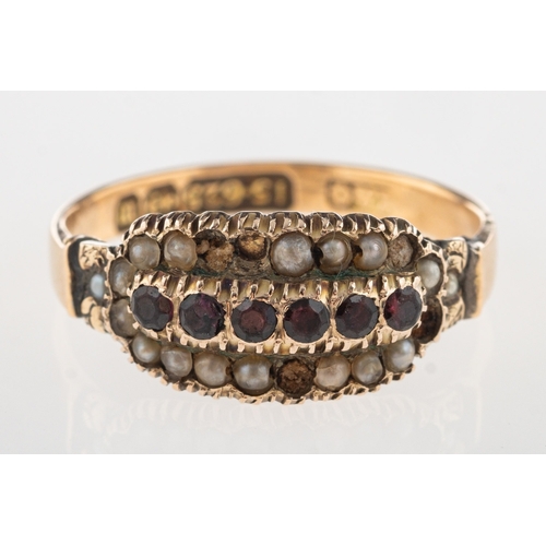 921 - A 15ct gold Victorian ring, set with a row of red circular-cut stones with a row of seed pearls eith... 