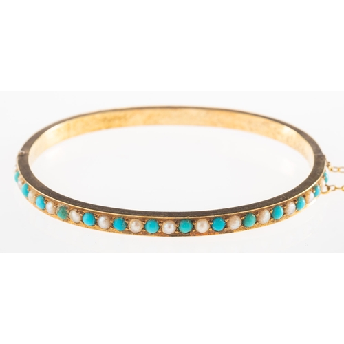 925 - A Victorian turquoise and seed pearl bangle, set with alternating turquoise cabochons and seed pearl... 