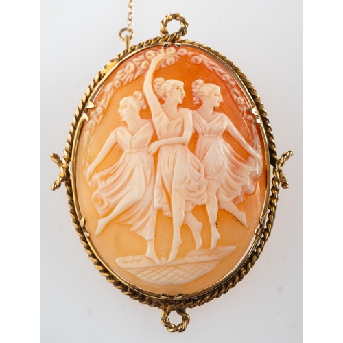 927 - A cameo brooch, a carved shell cameo brooch depicting the Three Grace's, in a rope twist surround wi... 