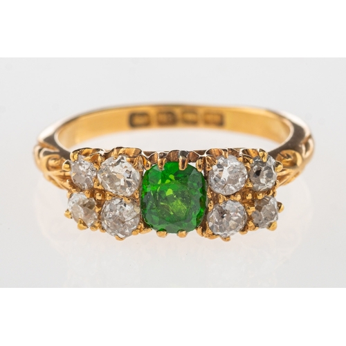 933 - An early 20th century 18ct gold ring, claw set to the centre with an oval-cut green stone, (possibly... 