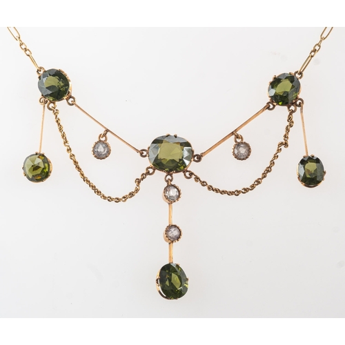 942 - An Edwardian Belle Epoque necklace, a fancy open-link chain leading to bar sections, claw set with t... 