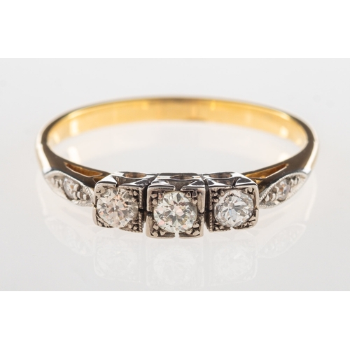 944 - An Art Deco three stone diamond ring, set with three older-cut diamonds in a square setting, with a ... 