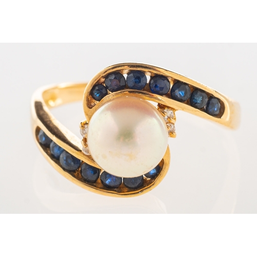 969 - A pearl, sapphire and diamond ring, a crossover designed ring set with a cultured pearl, pearl appro... 