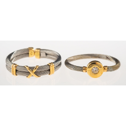 984 - A group of two bi-colour rings, one a ring with a white metal twisted wire band and yellow metal acc... 