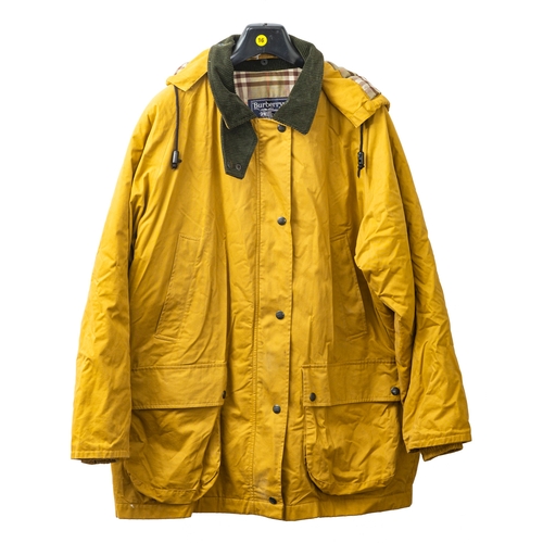 595A - Burberry. Two Burberry coats. A mustard yellow hooded jacket with green corduroy collar and classic ... 