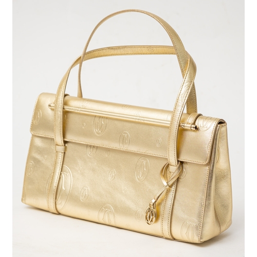 541 - Cartier. A gold monogrammed exterior, beige suede interior, gold hardware and gold safety bar inset ... 