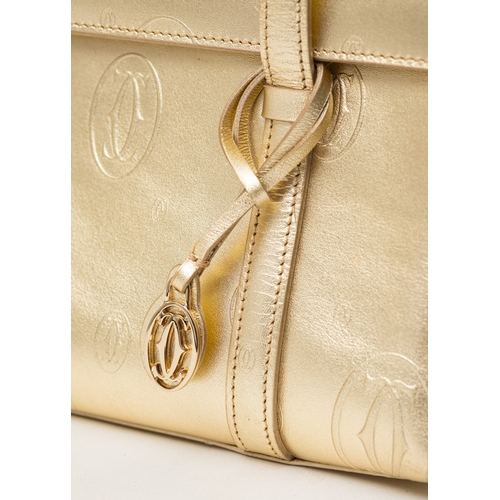 541 - Cartier. A gold monogrammed exterior, beige suede interior, gold hardware and gold safety bar inset ... 