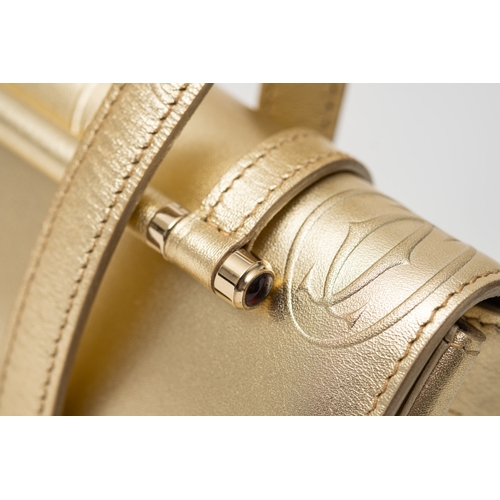 541 - Cartier. A gold monogrammed exterior, beige suede interior, gold hardware and gold safety bar inset ... 