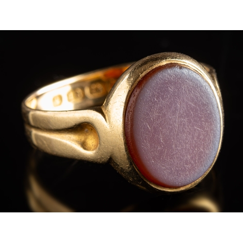 948 - A Victorian 18ct gold signet ring, set with an oval plaque of carnelian with an overlay of white sto... 