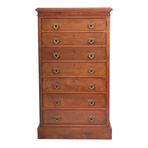 1005 - Maple & Co - A late 19th Century collectors walnut upright chest, the top with a bevelled edge, cont... 