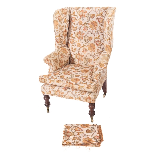 1012 - A Victorian stained beech wing frame armchair, fully upholstered in floral design beige fabric, on t... 