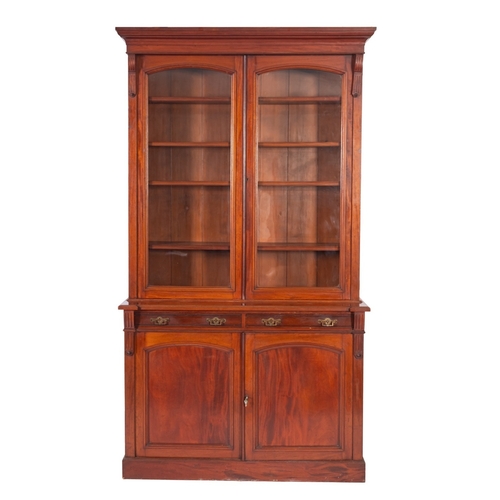 1014 - A Victorian mahogany bookcase, the upper part with a moulded cornice, fitted with adjustable shelves... 