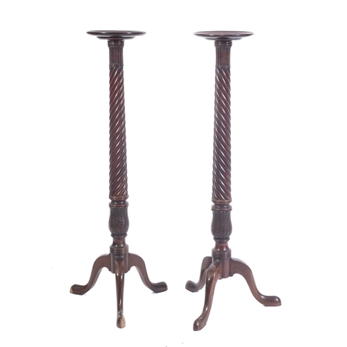 1019 - A pair of Victorian mahogany torchere or vase stands, in Regency style, late 19th century; with circ... 