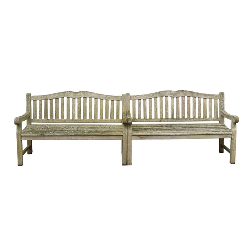 1183 - A set of three teak garden benches, late 20th century; the slatted backrests with serpentine toprail... 