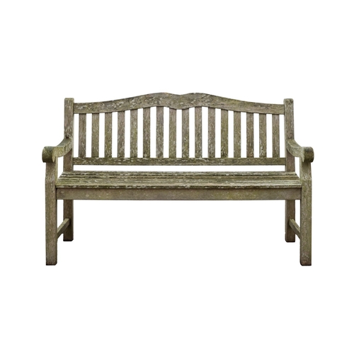 1183 - A set of three teak garden benches, late 20th century; the slatted backrests with serpentine toprail... 